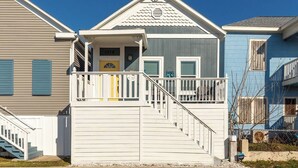 A two-story house with a front porch, a staircase, and a mailbox.