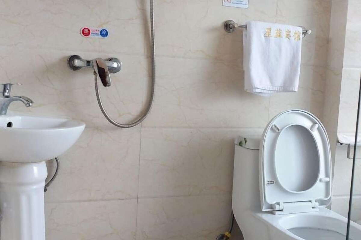 A bathroom with a sink, toilet, and shower.