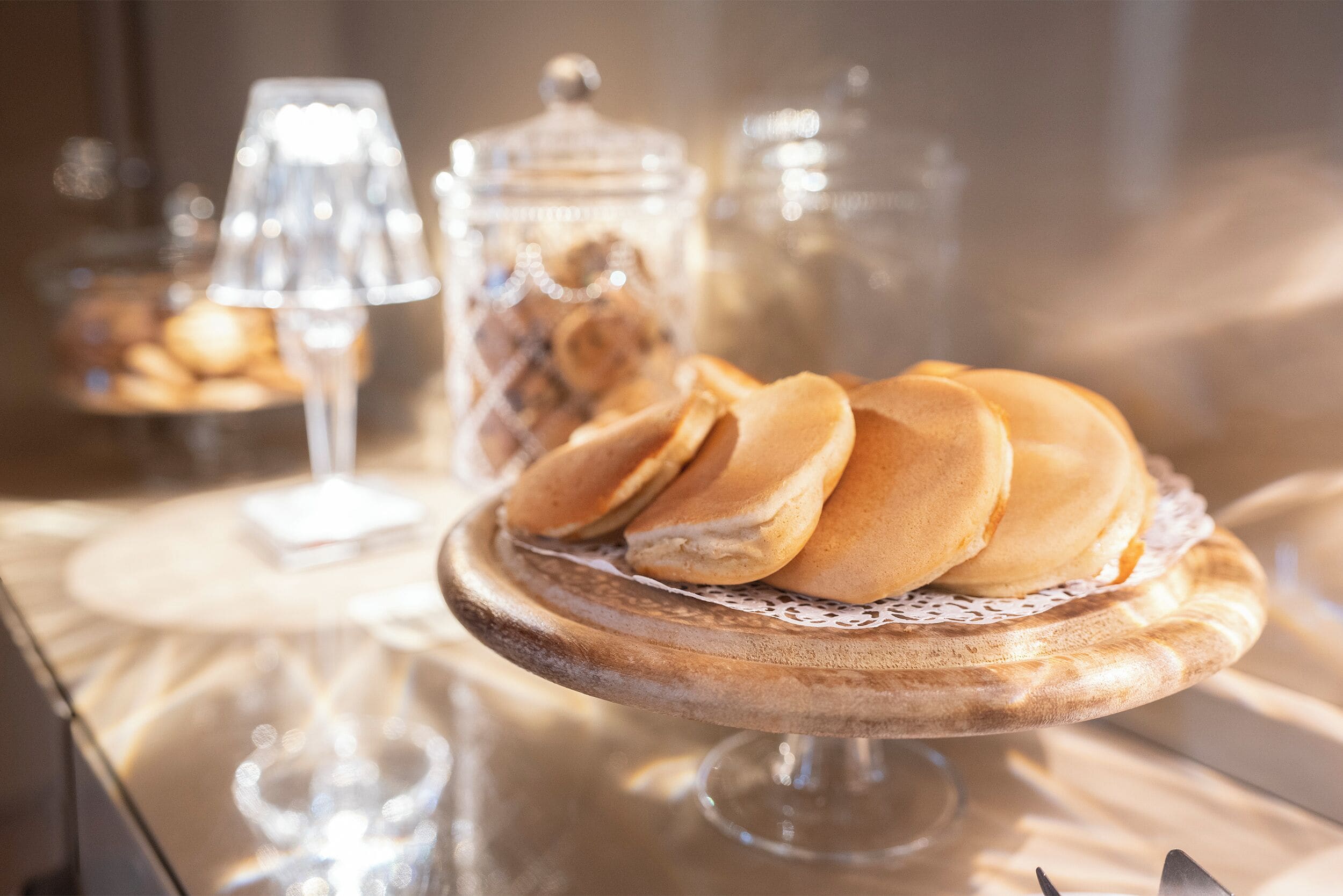 A dessert display with a variety of pastries on a wooden stand.