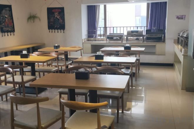 A classroom with tables and chairs arranged for seating.