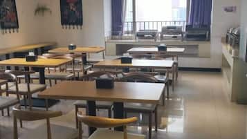 A classroom with tables and chairs arranged for seating.