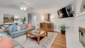 A living room with a sofa, coffee table, and TV.