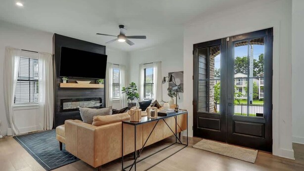 A modern living room with a sofa, coffee table, and a flat-screen TV.
