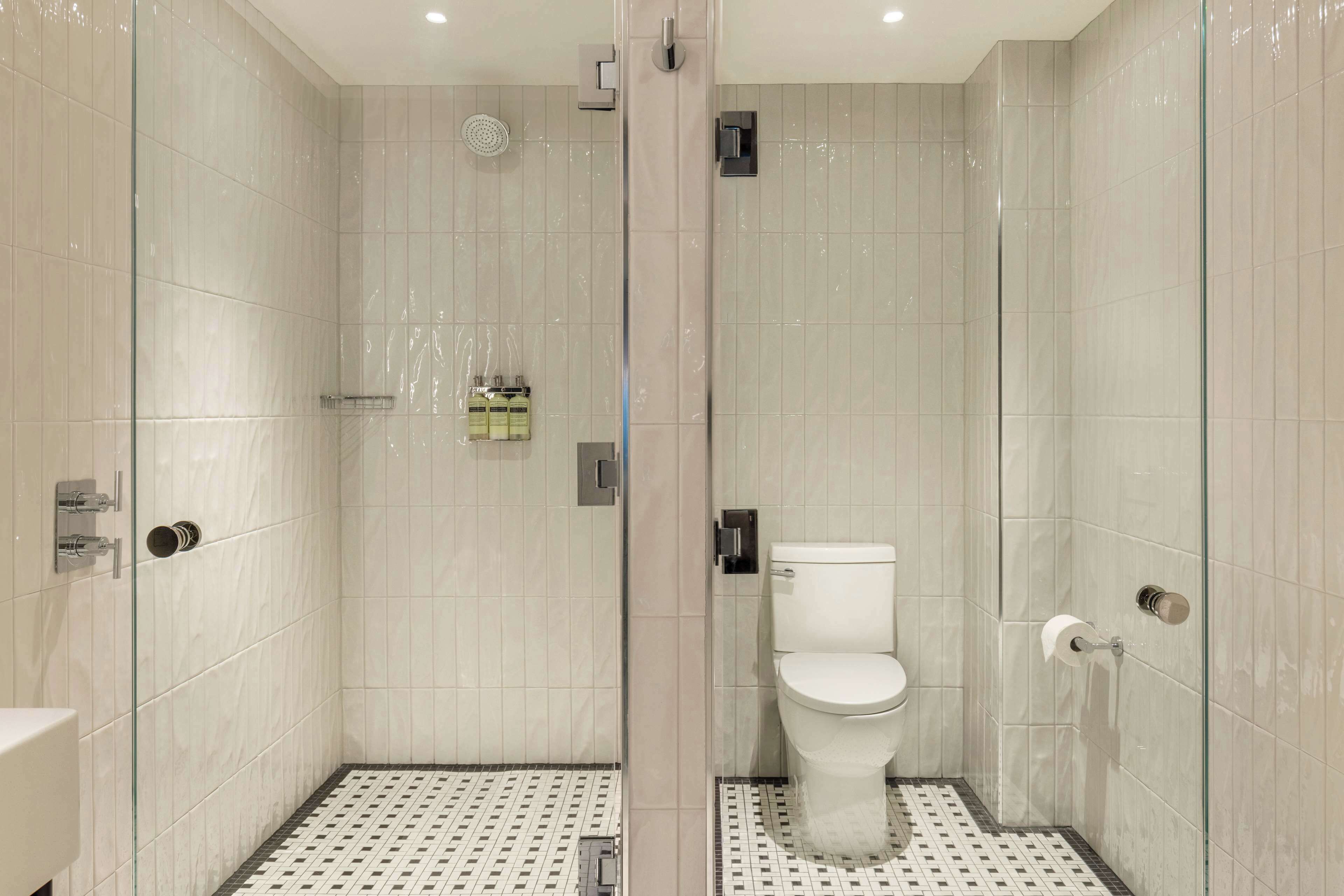 Une salle de bain moderne avec une douche à parois de verre, des toilettes et un lavabo.