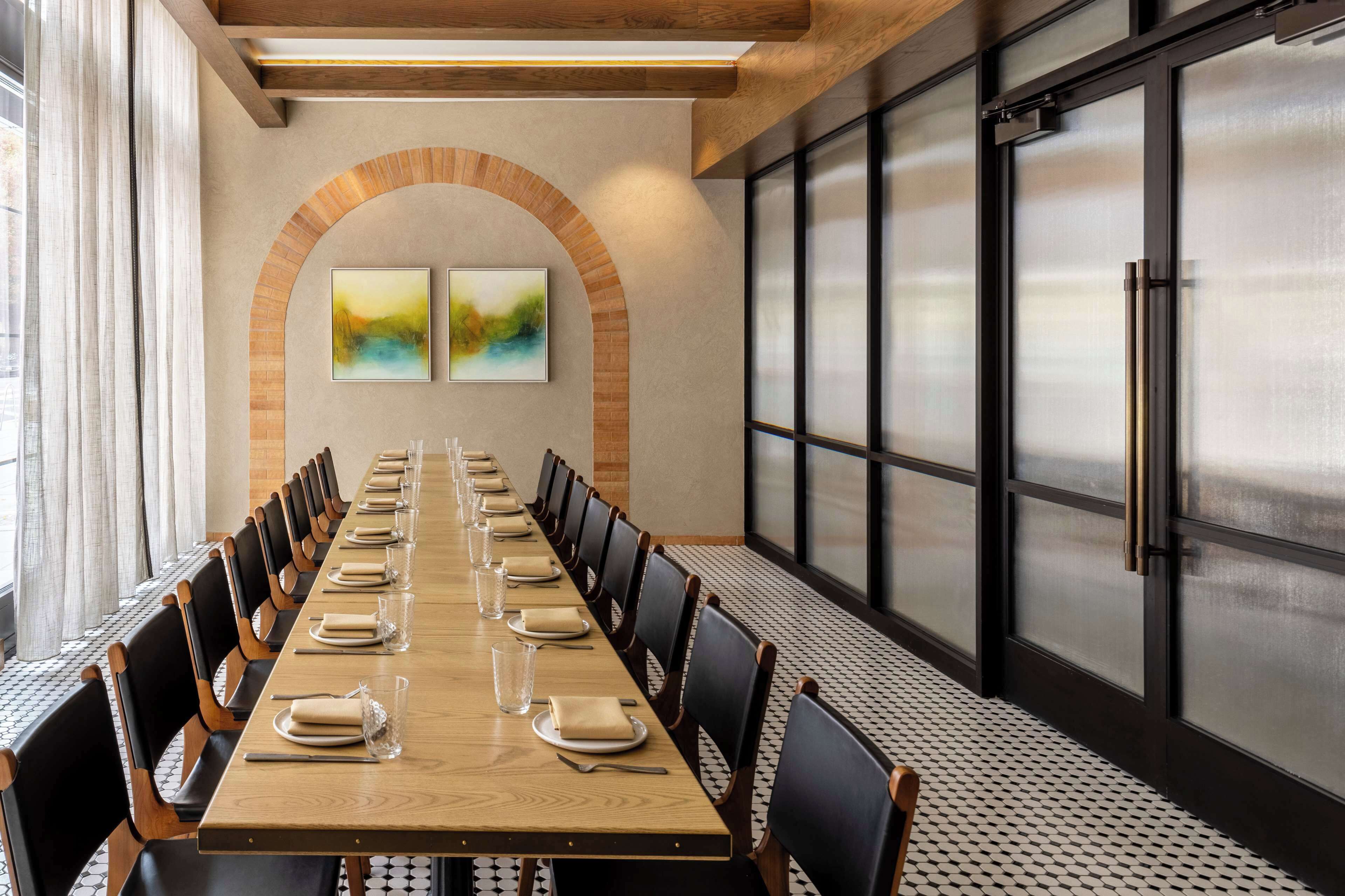 A conference room with a long table, chairs, and a large window.