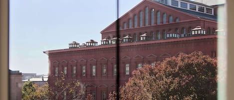 A red brick building with multiple windows and a flat roof.