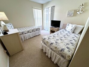 A hotel room with two beds, a TV, a desk, and a window with blinds. - Liquid Sunshine Villa (Haines City)