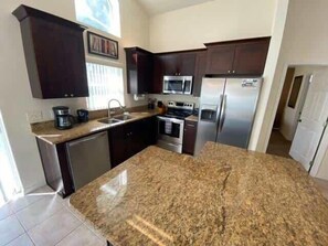 Microwave, dishwasher, cookware/dishes/utensils, paper towels - Southern Dunes Pool Villa (Haines City)