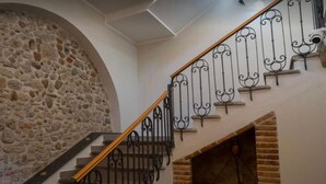 A staircase with a stone wall on one side and a metal railing on the other. - Hice Room (Catanzaro)