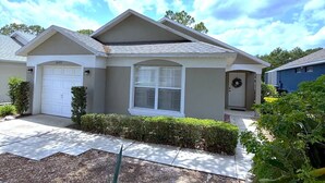 A single-story house with a garage, a front porch, and a well-maintained lawn.