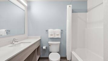 A modern bathroom with a sink, toilet, and shower.
