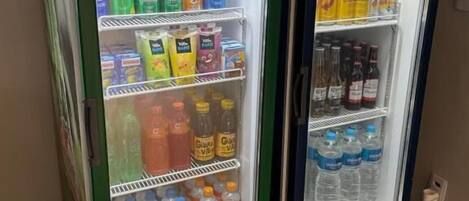 Two beverage vending machines, one labeled 'Guaraná Antarctica' and the other 'Pepsi', stocked with various drinks.