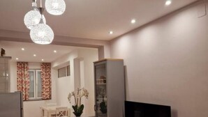 A compact living space with a dining area, a television, and a cabinet. - Pansion Belvedere - One Bedroom (Magnolia) (Mali Losinj)