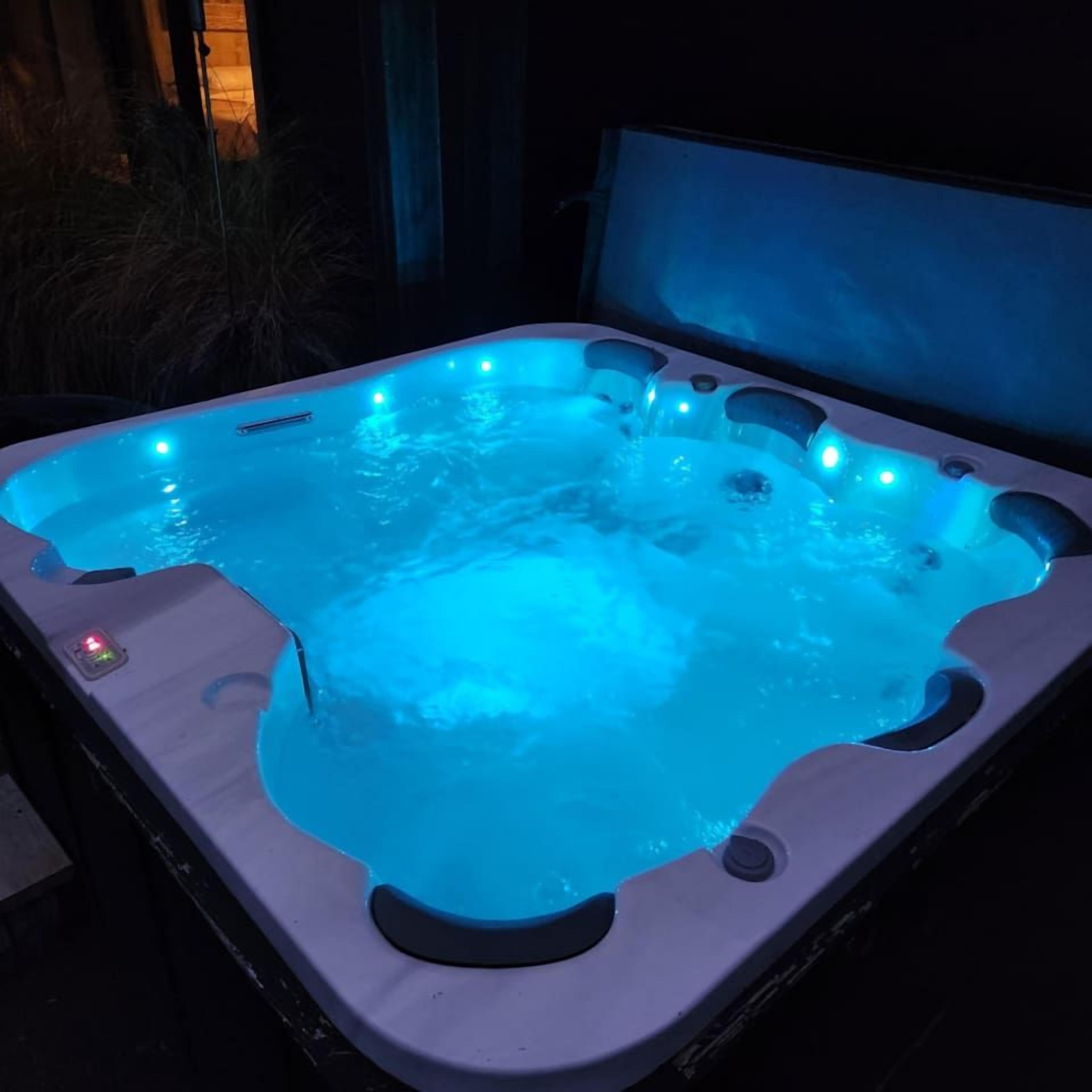 A hot tub with multiple jets and LED lighting.