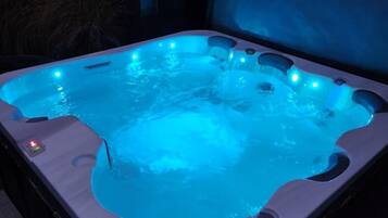A hot tub with multiple jets and LED lighting.