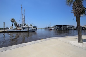 Boats docked at the marina, surrounded by a covered structure and a palm tree.