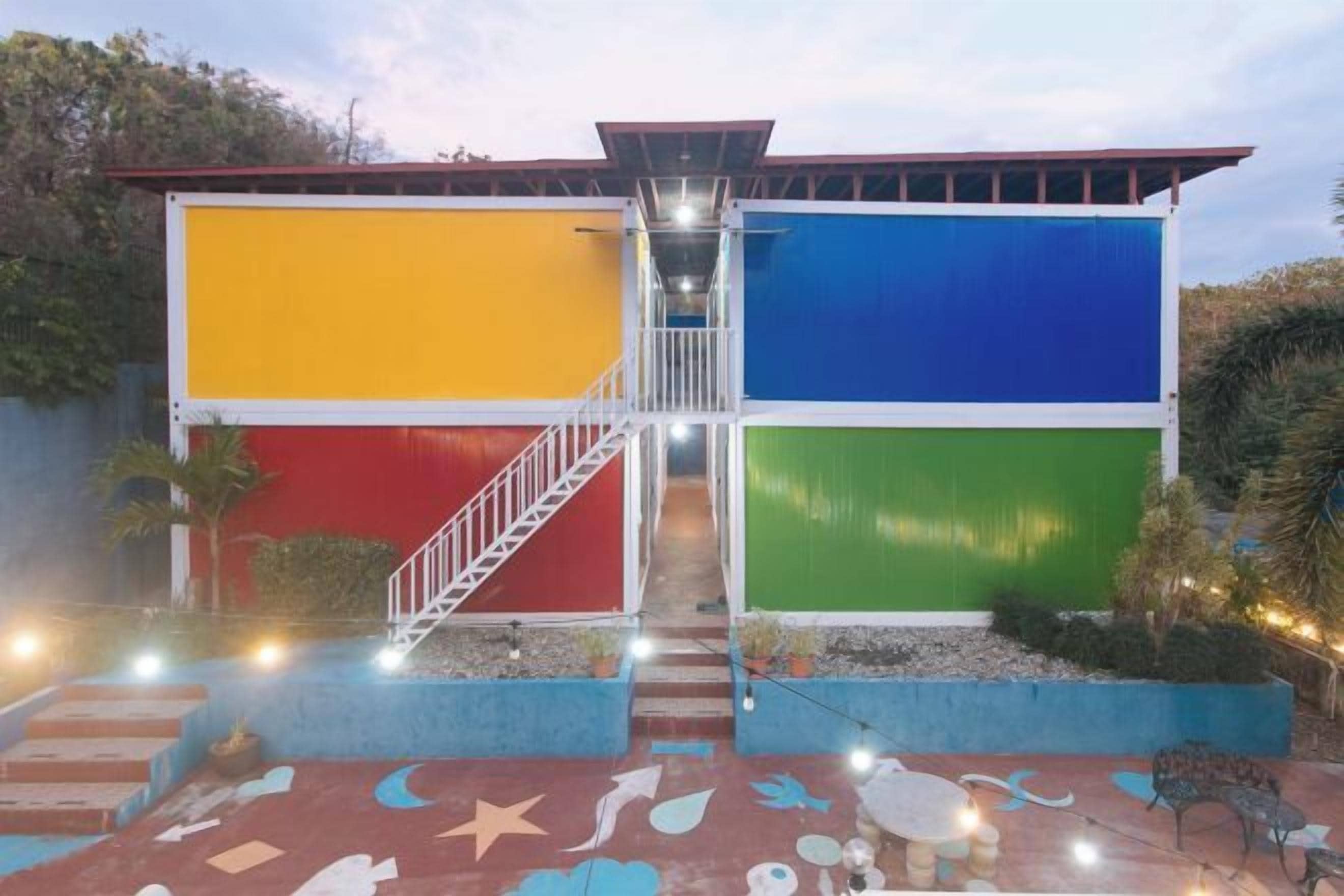 A colorful building with a staircase leading to a flat roof.