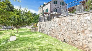 A stone building with a balcony, surrounded by a grassy area and trees. - Charming 3-BR Villa for 6 with private pool, close to the sea (Sumartin)