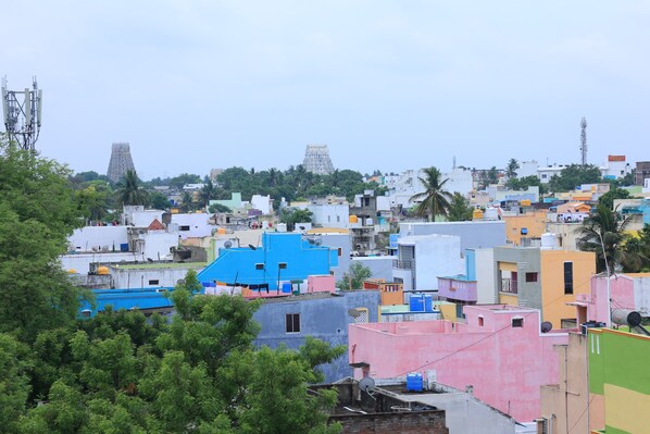 A densely packed urban area with various buildings, including a prominent temple-like structure in the background. - TCS Residency (Kanchipuram)