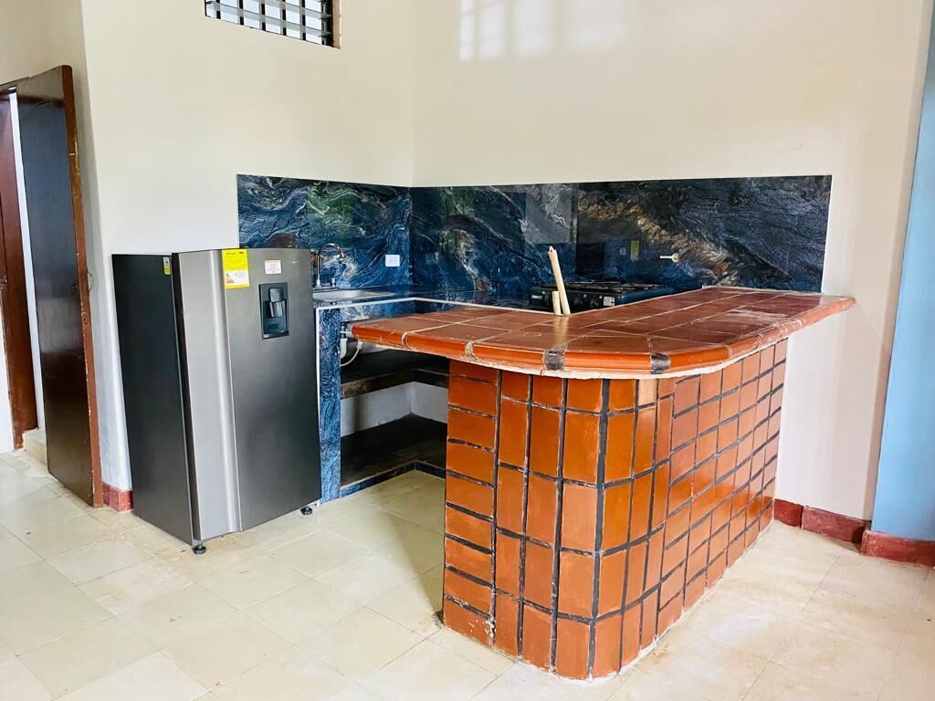 A kitchen with a built-in refrigerator, a sink, and a tiled backsplash.