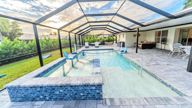 A covered outdoor swimming pool with a view of the surrounding area. - Unwind in Paradise (Cape Coral)