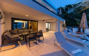 Relax in style with a contemporary dining set and comfortable seating area.