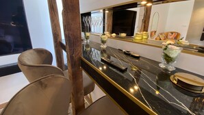 A modern bathroom with a black marble countertop, a large mirror, and a wooden column. - 19A - The Seventh Heaven, cocoon lover (Tulle)