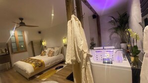 A modern bedroom with a bed, a massage chair, and a bathtub. - 19A - The Seventh Heaven, cocoon lover (Tulle)