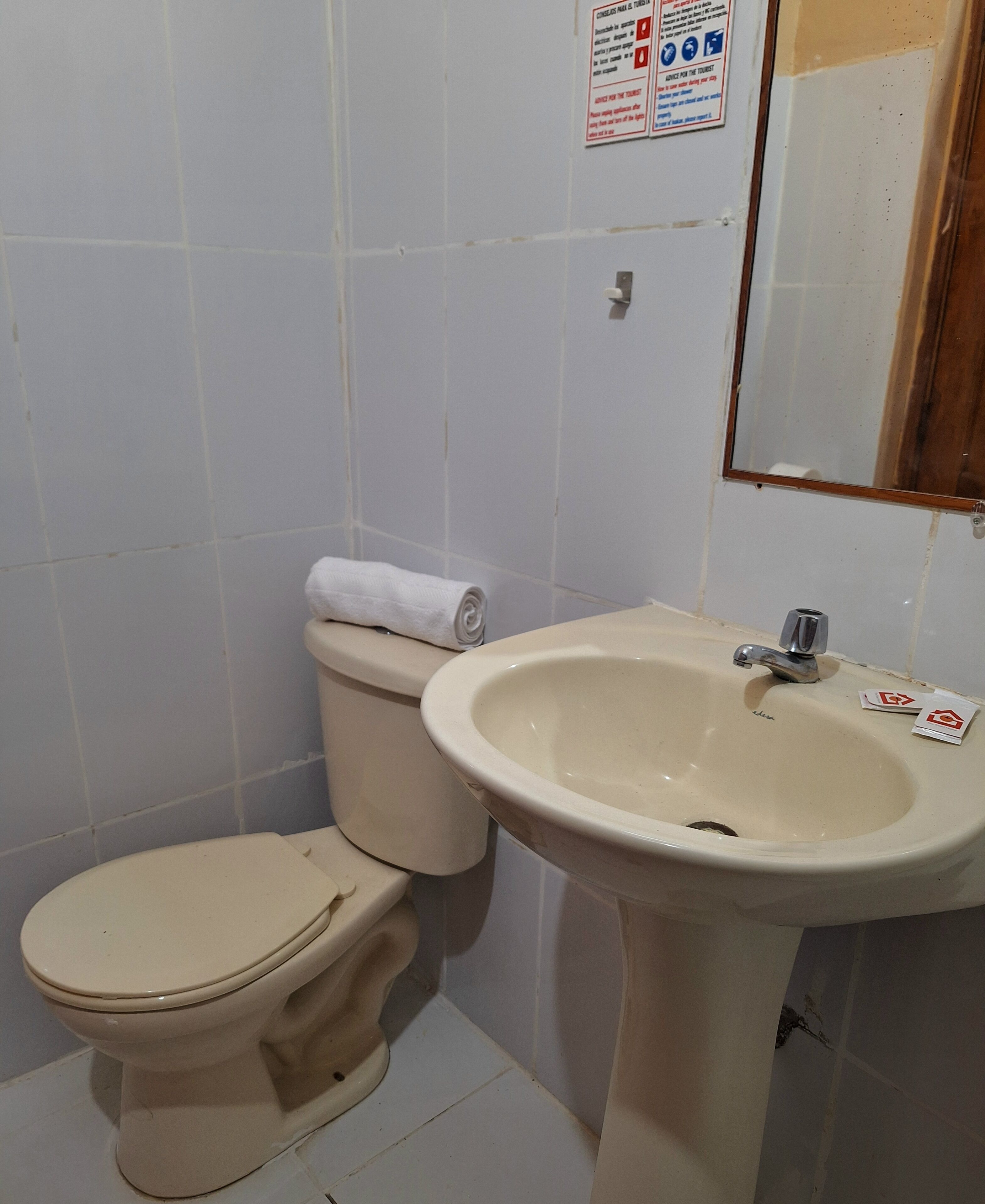 A bathroom with a toilet and a sink.