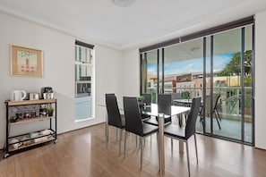 Enjoy a meal at the dining table or relax in the outdoor area through the large sliding door.