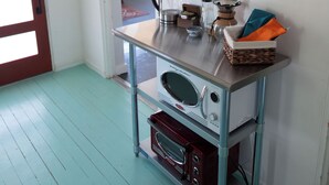 A kitchen with a stainless steel countertop, a coffee maker, and a microwave. - La Cochera Private Apartment - No Cleaning Fee (Alpine)