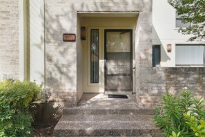 A building entrance with a door, a mailbox, and a number plate. - Cozy and Spacious Home at Gated Community. (San Antonio)