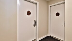 Two white doors with numbers 131 and 132, each with a keyhole and a handle. - Charming Killington Studio w/ Pool. Bus Route. Ski Rental Deals! - Killington Center Suites 131 (Killington)