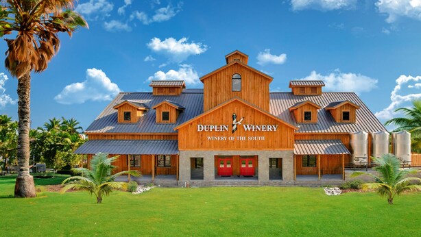 A large, wooden winery building with a prominent sign reading "DUPLIN WINERY WINERY OF THE SOUTH". - Salty Kisses - 3 miles to beach, pool, gameroom theater room, close to Pier Park (Panama City Beach)