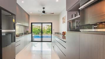 Luxury Villa | Private kitchen | Full-size fridge, microwave, oven, stovetop