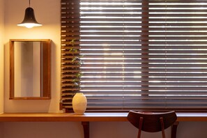 A room with a wooden desk, a mirror, a vase, and a chair. - Soolim Hotel by Aank Sokcho (Sokcho)