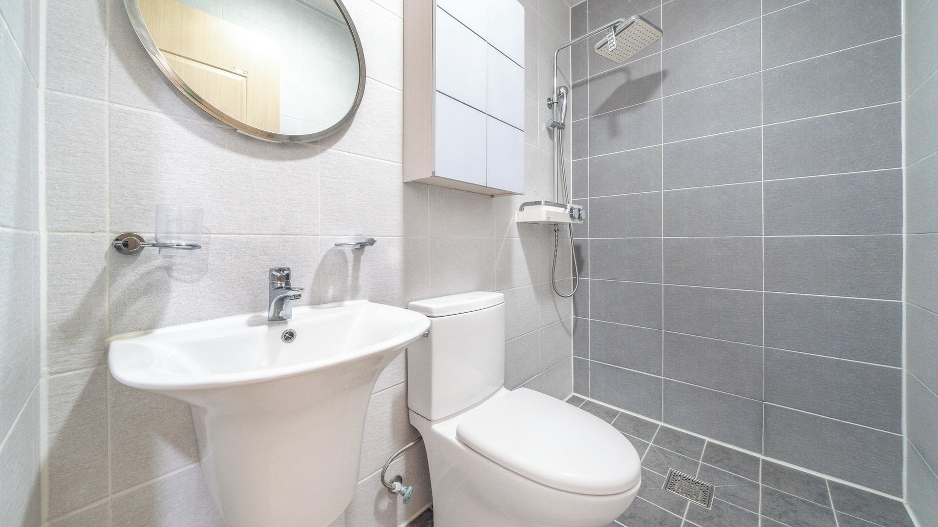 A bathroom with a sink, toilet, and shower.
