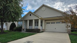 A single-story house with a front porch, a garage, and a well-maintained lawn. - Coastal Beauty-Bike to Beach (Lewes)