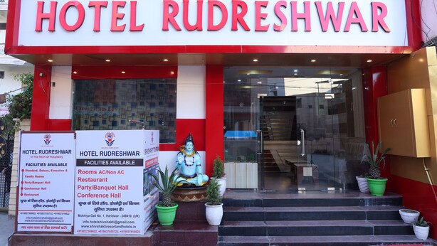 A hotel entrance with a sign reading "HOTEL RUDRESHWAR" and a statue of a deity. - Hotel Rudreshwar (Haridwar)