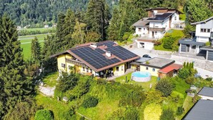 A residential area with houses, a swimming pool, and solar panels on the roofs. - zur schönen Aussicht by Interhome (Wörgl)
