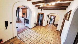 A spacious hallway with exposed wooden beams, a tiled floor, and a view into a kitchen area. - zur schönen Aussicht by Interhome (Wörgl)