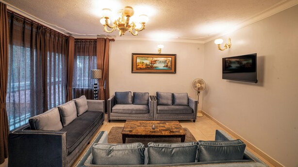 Apartment, 2 Bedrooms | Living area | 52-inch LCD TV with cable channels, offices, printers - A'lure Hotel & Residences (Kampala)