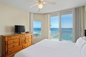 Enjoy ocean views from the balcony and relax in the spacious room with a large bed and comfortable seating area.