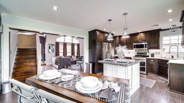 A modern kitchen with dark wood cabinets, stainless steel appliances, and a central island. - 'Peace & Tranquility': Home 2 Mi to Dtwn Tulsa! (Tulsa)