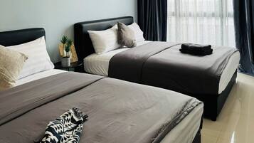 Ein Hotelzimmer mit zwei Betten, jedes mit einem dunklen Kopfteil und einer Bettdecke in neutralen Farbtönen. Auf dem Nachttisch neben einem Bett steht ein kleiner Blumentopf.