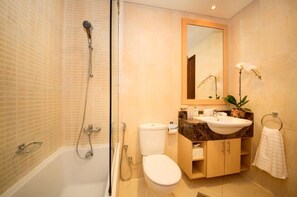 Enjoy a refreshing shower in the bathroom, featuring a glass-enclosed shower area with handheld showerhead and wall-mounted faucet.