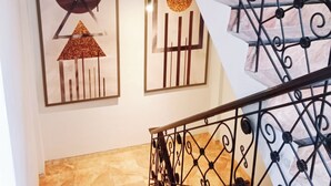 A staircase with a metal railing and marble steps. - Hotel Nara Arta Syariah (Surabaya)
