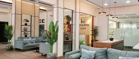 A modern living room with a sofa, coffee table, and decorative plants.