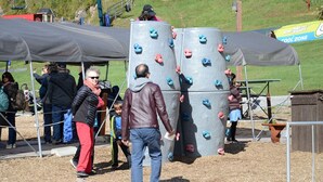 A climbing wall with multiple holds and a shaded area with a tent. - Cozy Lodge in the Mont Tremblant Ski Village (Mont-Tremblant)