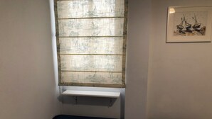 A room with a bed, a window with a view of a landscape, and a framed artwork on the wall. - Almería Centro (Almería)